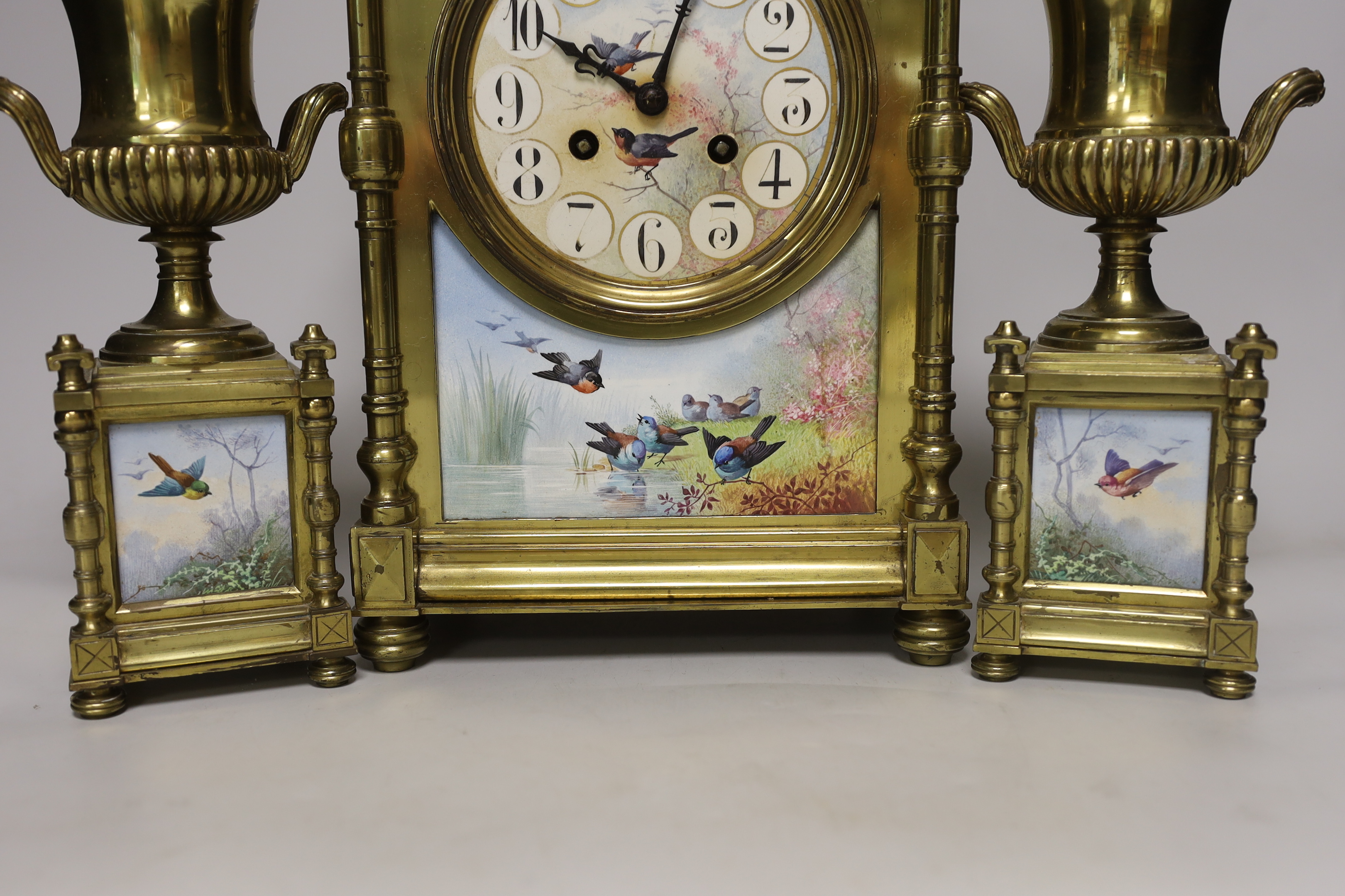 A French Aesthetic period brass and porcelain panelled clock garniture, clock 34cm high